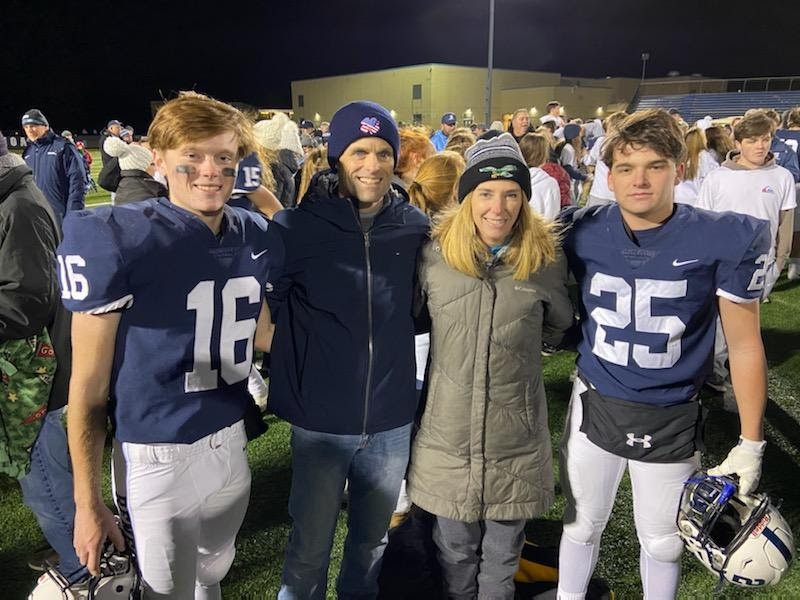 John Bialous celebrating a football victory with his sons.