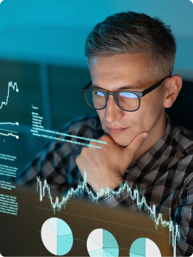 Focused Analyst Examining Data Visualizations and Charts on Screen