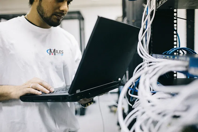 IT worker maintaining a server rack