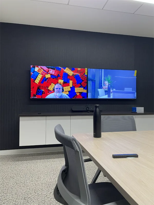 Technicians testing conference room equipment