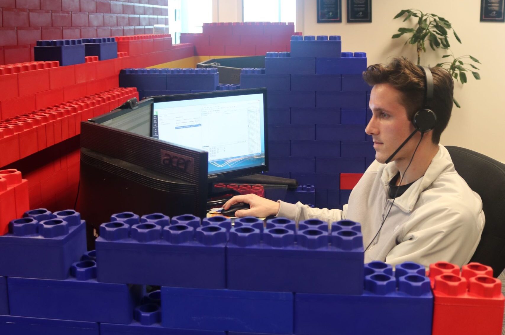 An onsite IT team member looks at a computer screen while on a support call