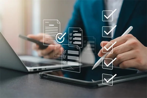 Business performance monitoring concept, businessman using tablet and laptop Online survey filling out, digital form checklist, blue background.