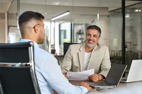 Two busy happy businessmen partners talking at office meeting.