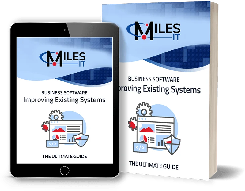 Miles IT “Business Software: Improving Existing Systems — The Ultimate Guide” displayed as a digital guide on a tablet alongside a printed book, with software, gear, and security graphics.