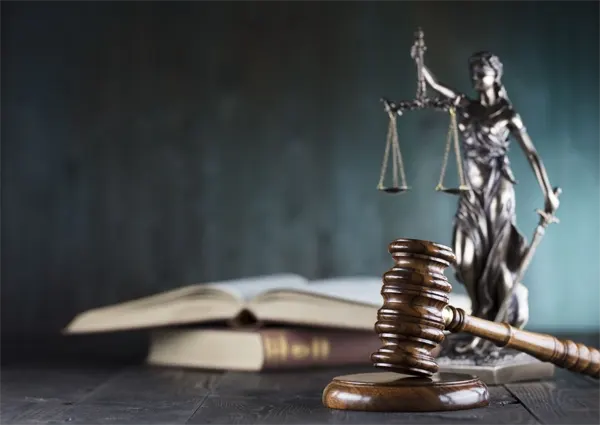 Gavel in front of legal scales