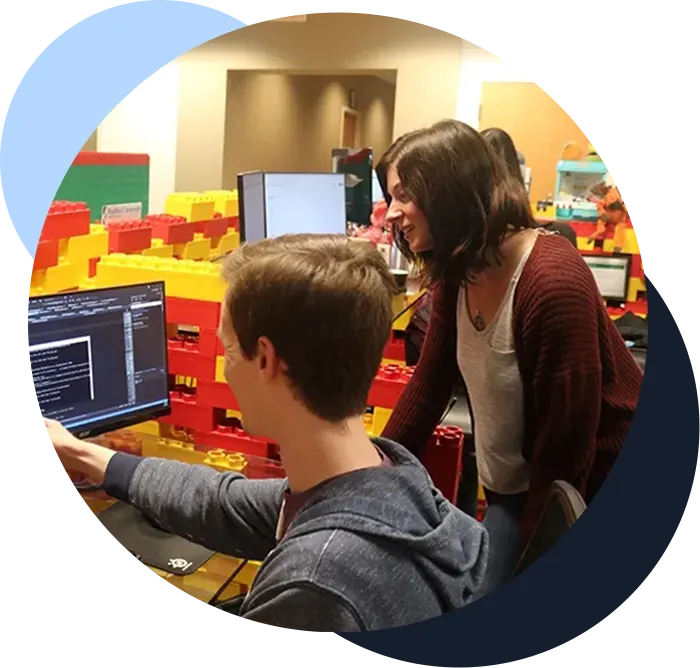 Software team points at computer to troubleshoot software challenges