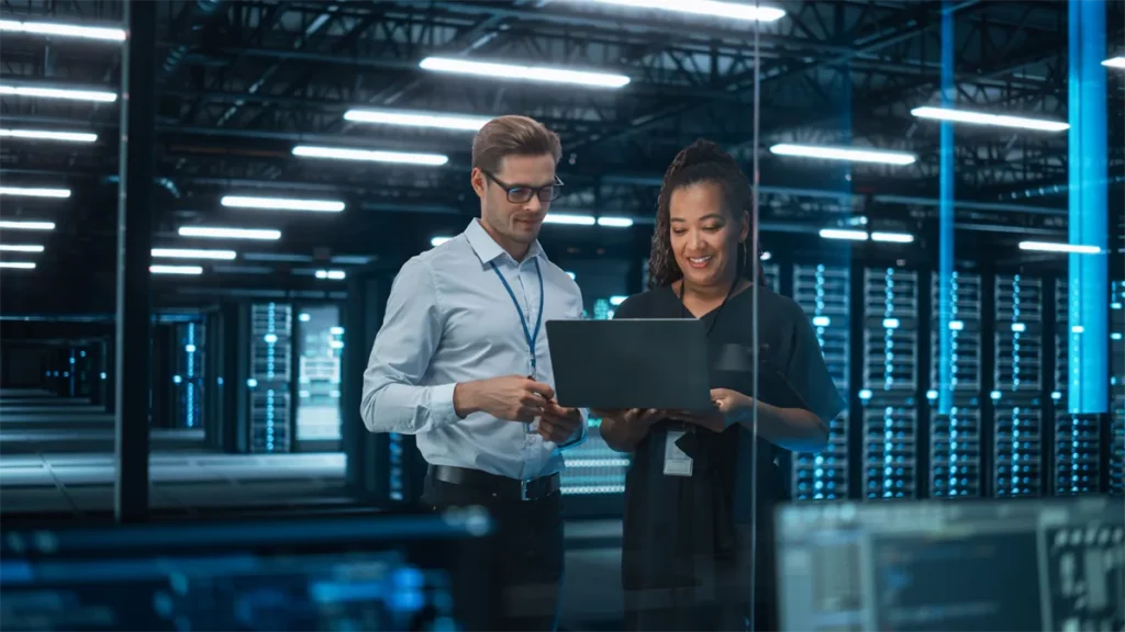 Man and woman in a server room reviewing data