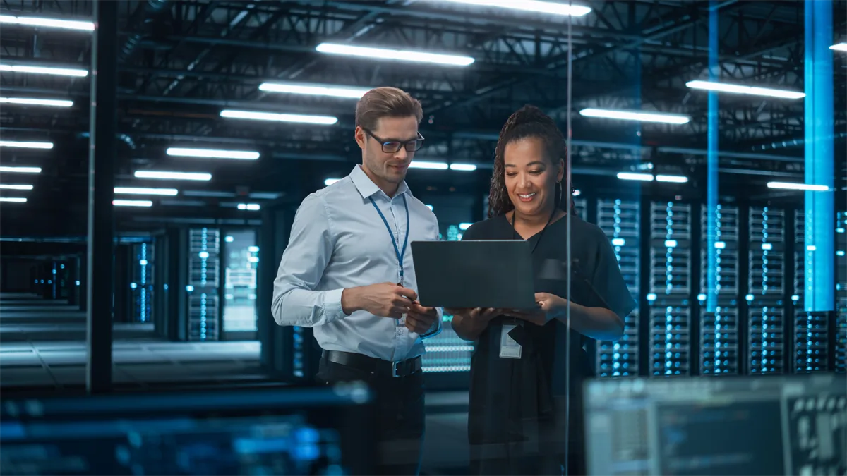 Man and woman in a server room reviewing data