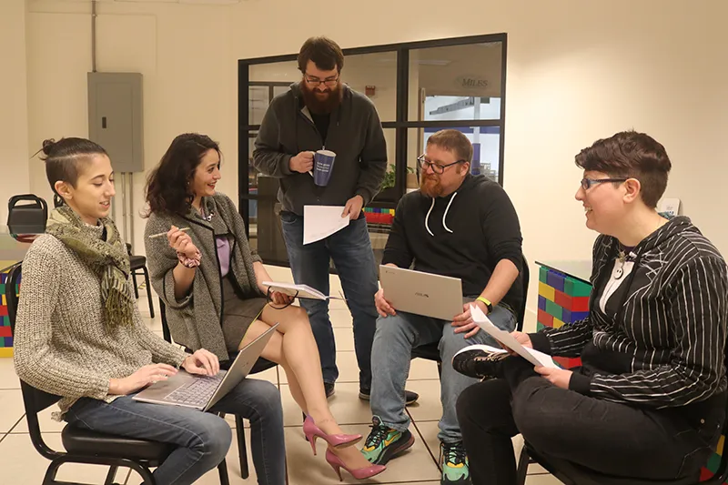 Marketing services team engaging in a group content meeting in a conference room