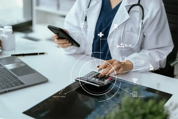 Doctor in accounting department using a calculator and taking notes