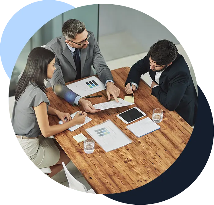 Meeting, discussion and business people with paperwork in office for review, budget report or project proposal.