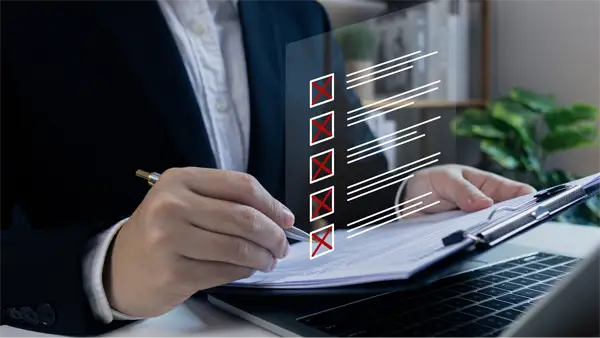 Businessman tick X mark to rejected document checklist