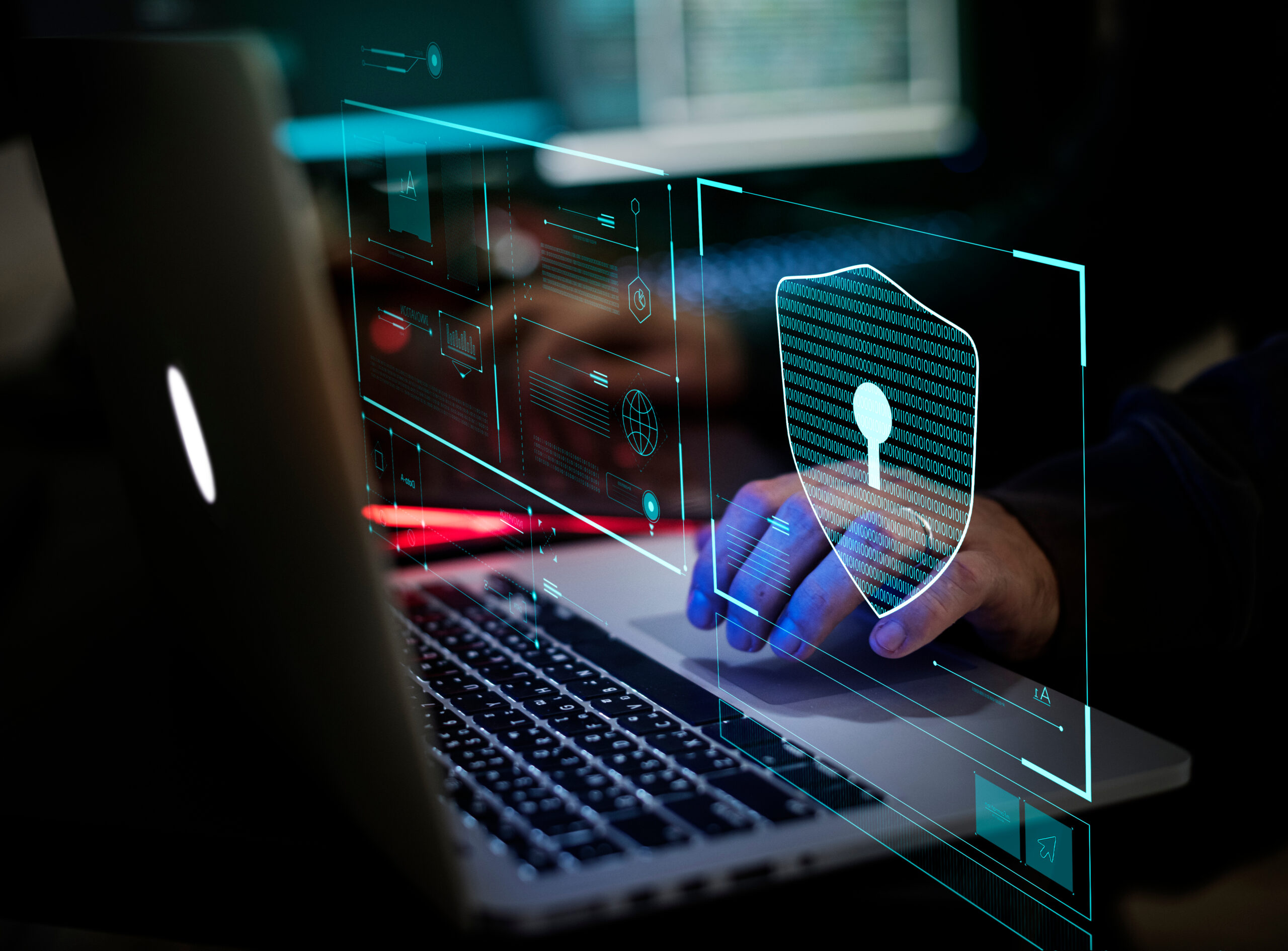 Digital crime by an anonymous hacker working on laptop