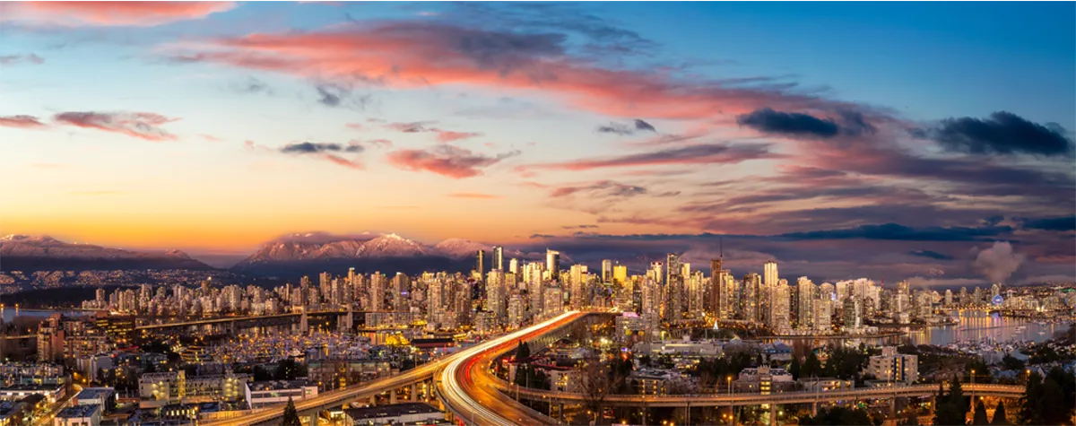 Aerial Panoramic view of Downtown Vancouver, Cambie Bridge, and False Creek. Picture taken during a cloudy sunset. Colorful sky Overlay.