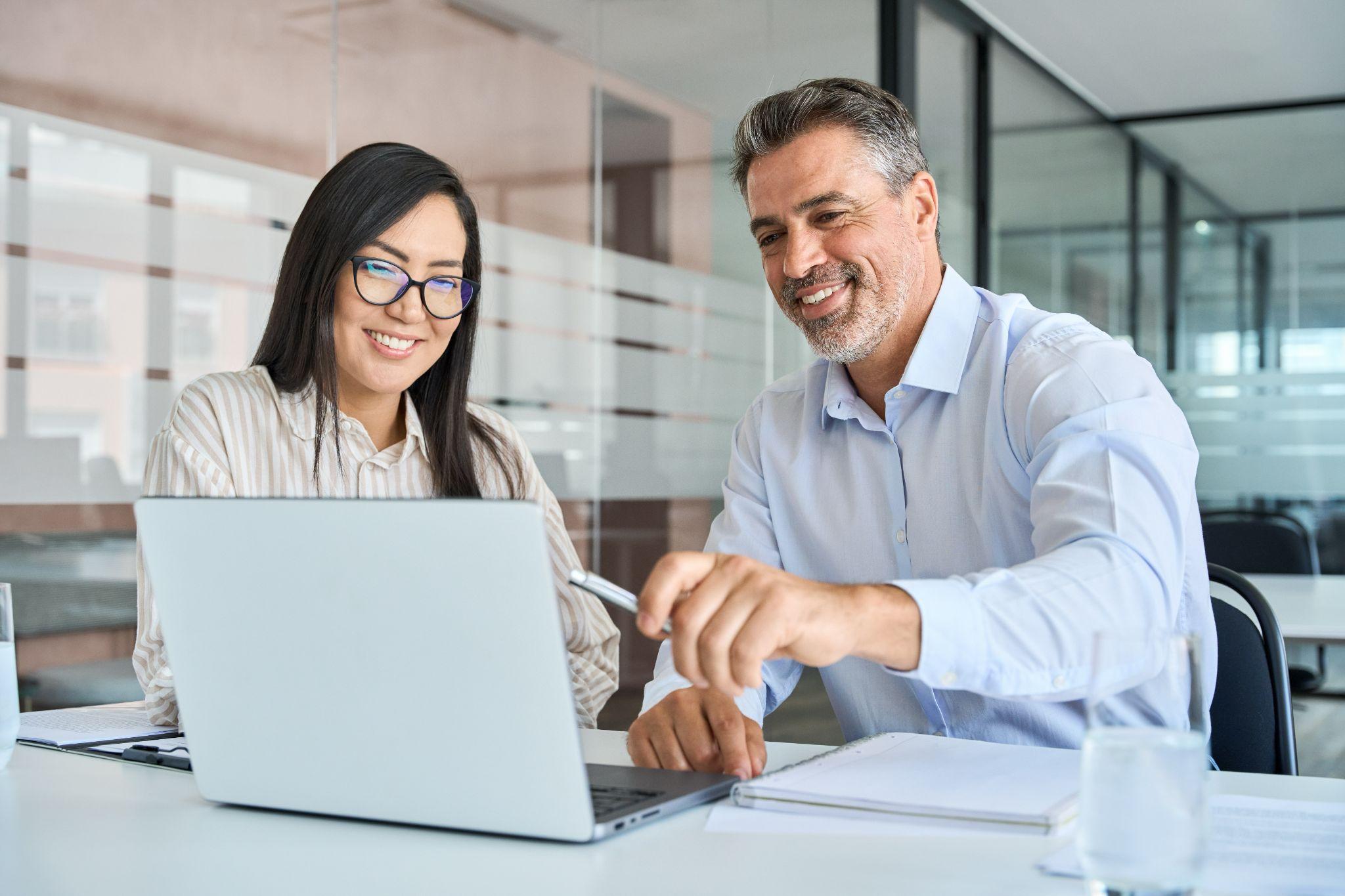it-consultant-discussing-digital-transformation-opportunities-with-business-owner-looking-at-laptop-screen-together